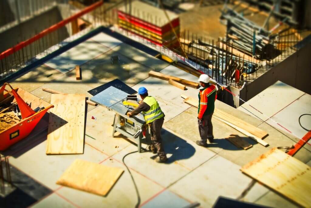 Multiple construction workers, working on a site.